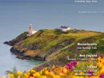 Travel & Culture Magazine Cover Summer/Fall 2024 - yellow and pink spring flowers on the hills over looking a lighthouse on a cliff and the ocean