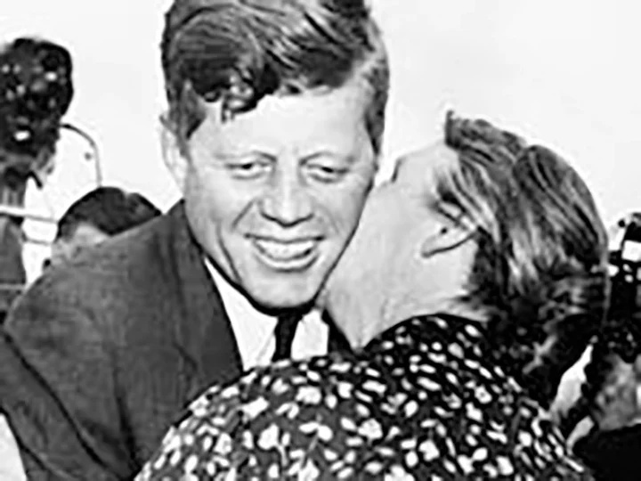 An Irish woman kisses JFK on the cheek