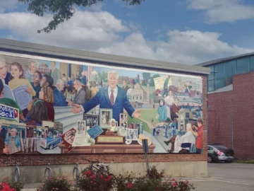 Mural painted on a brick building illustrating Tip O'Neill's interactions with the community