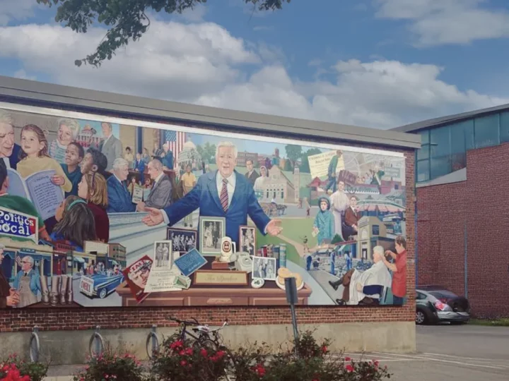 Mural painted on a brick building illustrating Tip O'Neill's interactions with the community