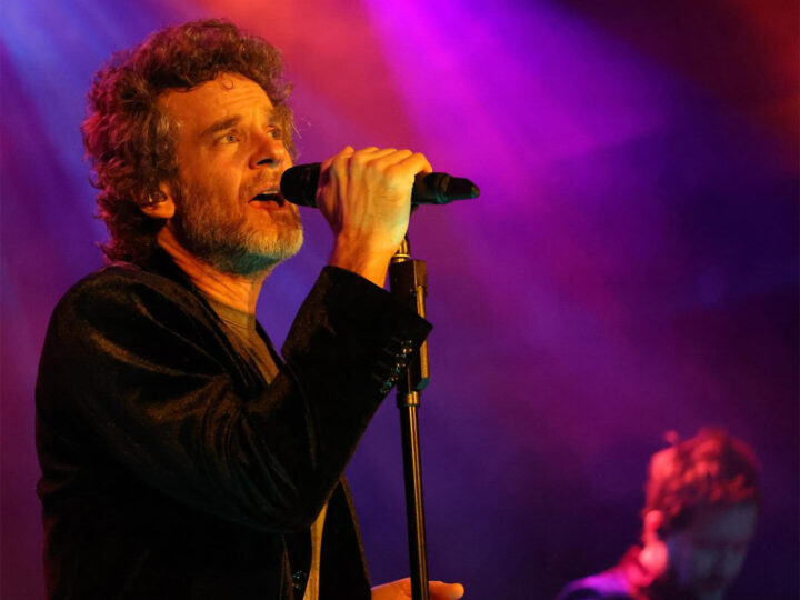 Carbon Leaf lead singer belting into a microphone, red and purple lighting