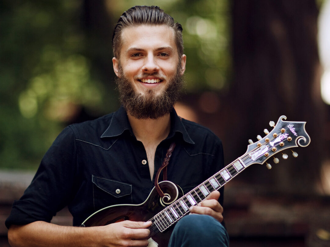 Jacob Joliff in black demin holding a mini-guitar (photo by Laura Dart)