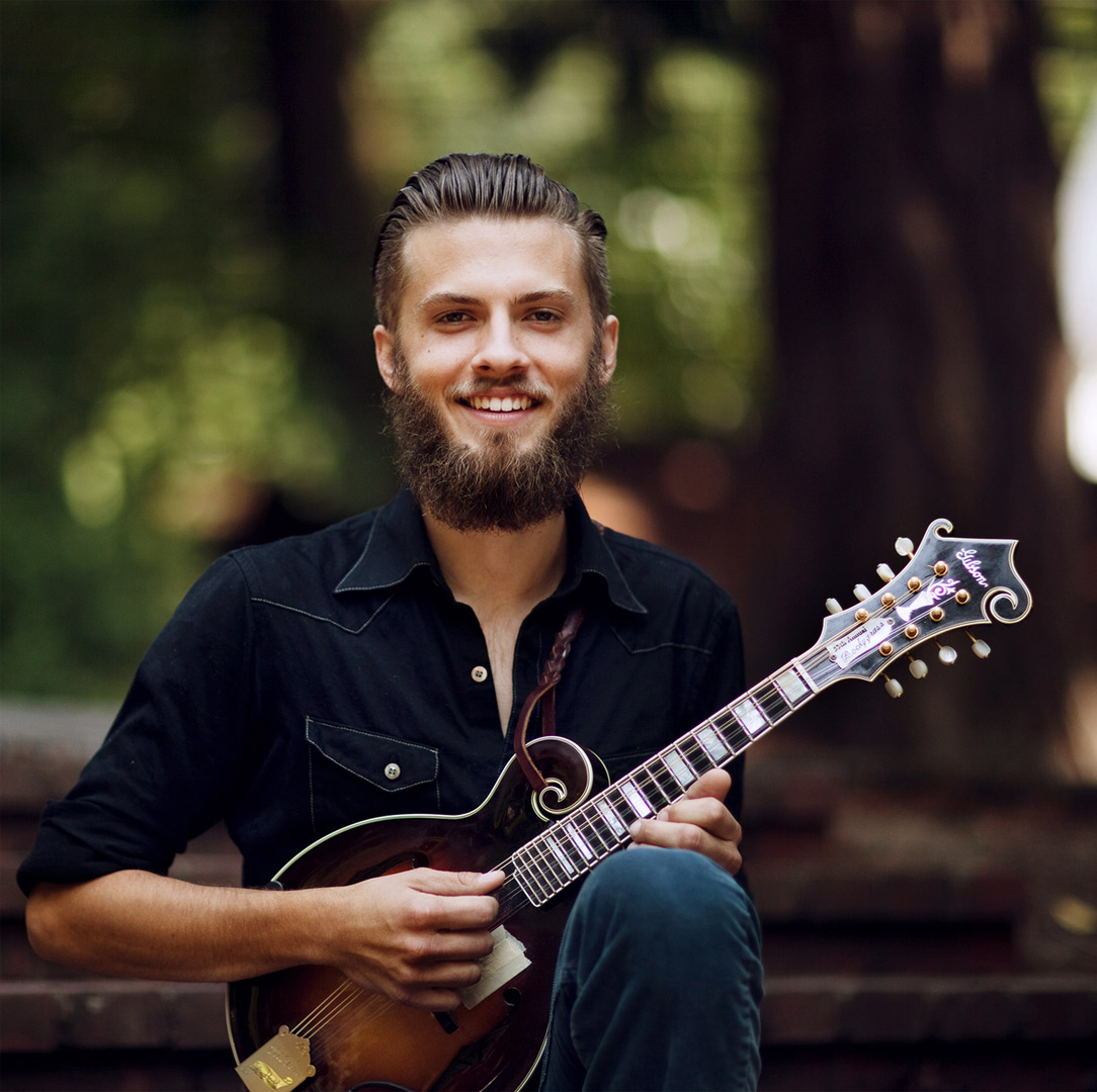 Jacob Joliff in black demin holding a mini-guitar (photo by Laura Dart)