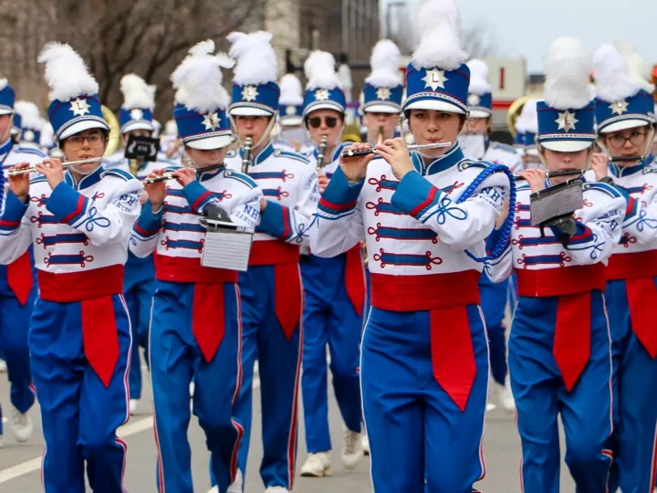 Marching band playing wind instruments in parade