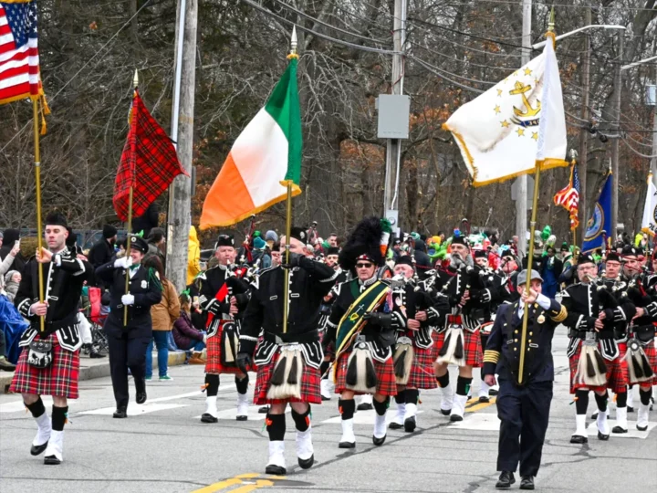 People in kilts marching in Saint Patrick's Day Parade in Providence Rhode Island.