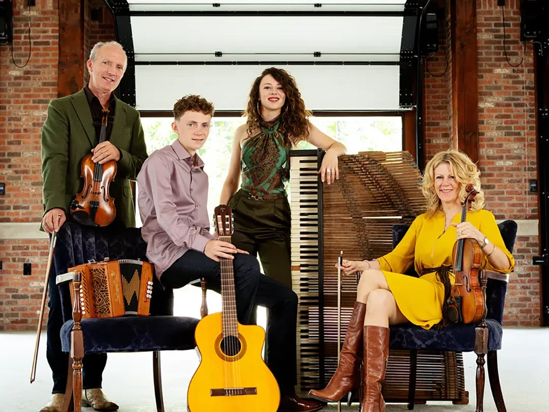 Four on the Floor band members posed holding their instruments
