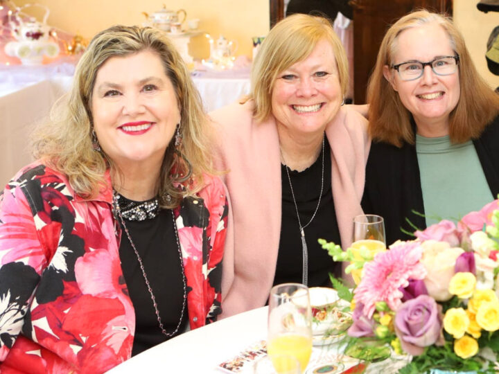 Three fashionable women enjoying an afternoon of tea