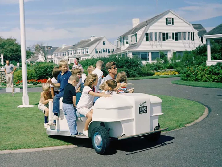 JFK and family in a golf cart