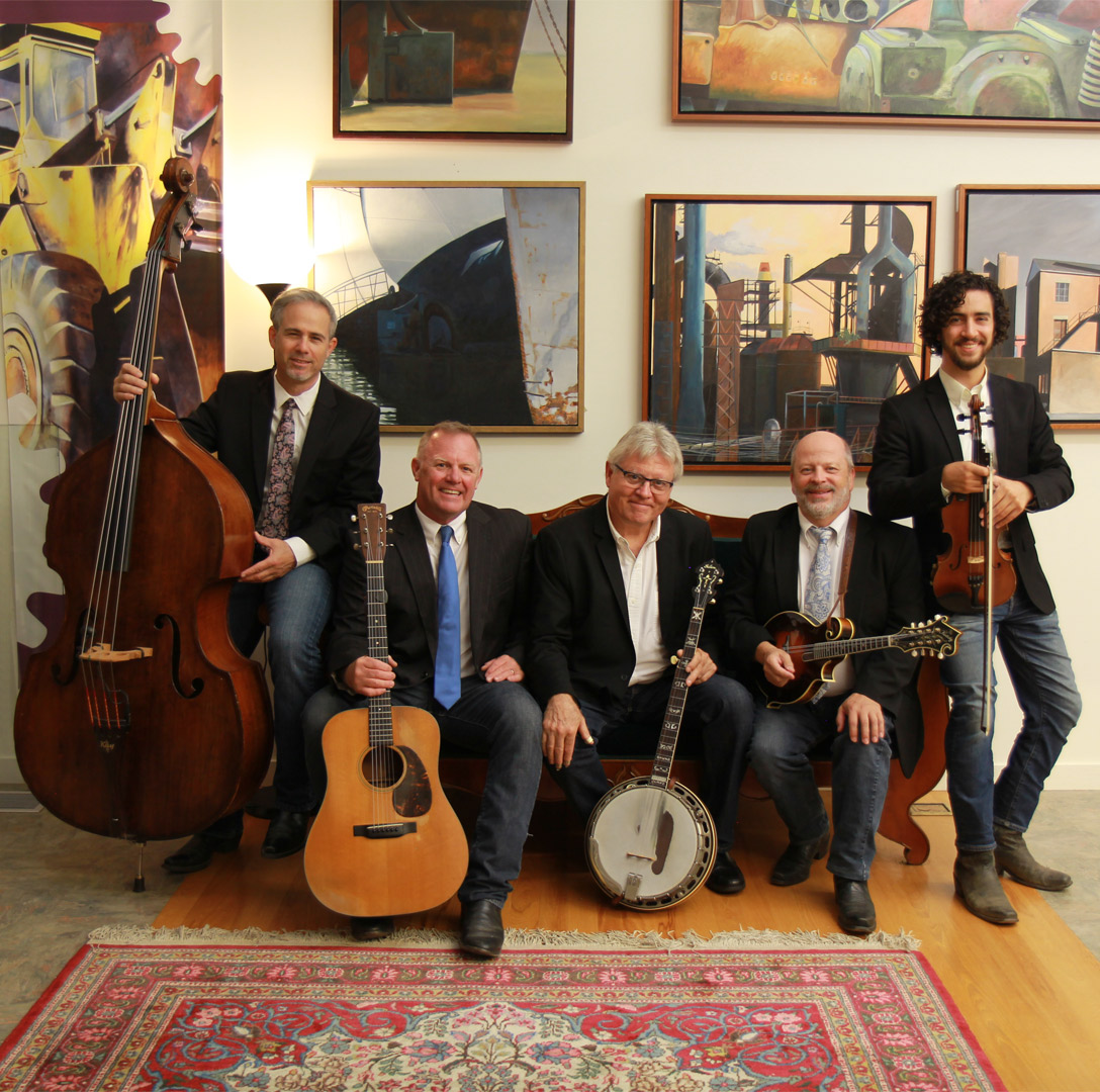 Rock Hearts Band sitting on a couch with their instruments in an art gallery